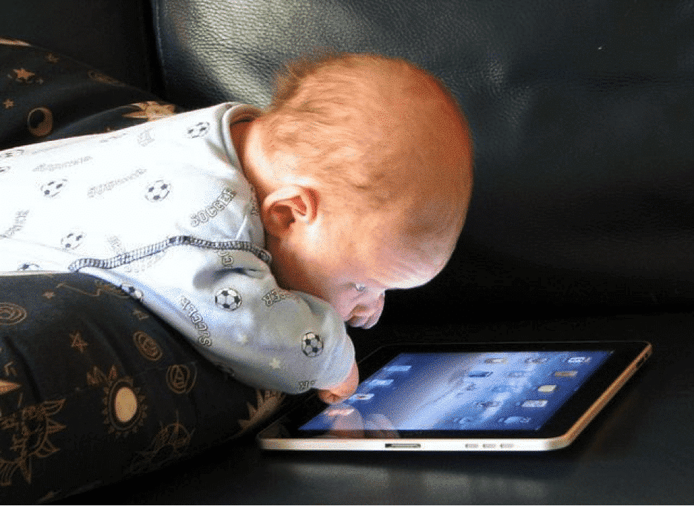 Infant participating in screen time