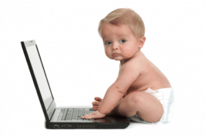 baby sitting at laptop